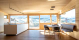 Spacious kitchen interior featuring clean surfaces and subtle lighting.