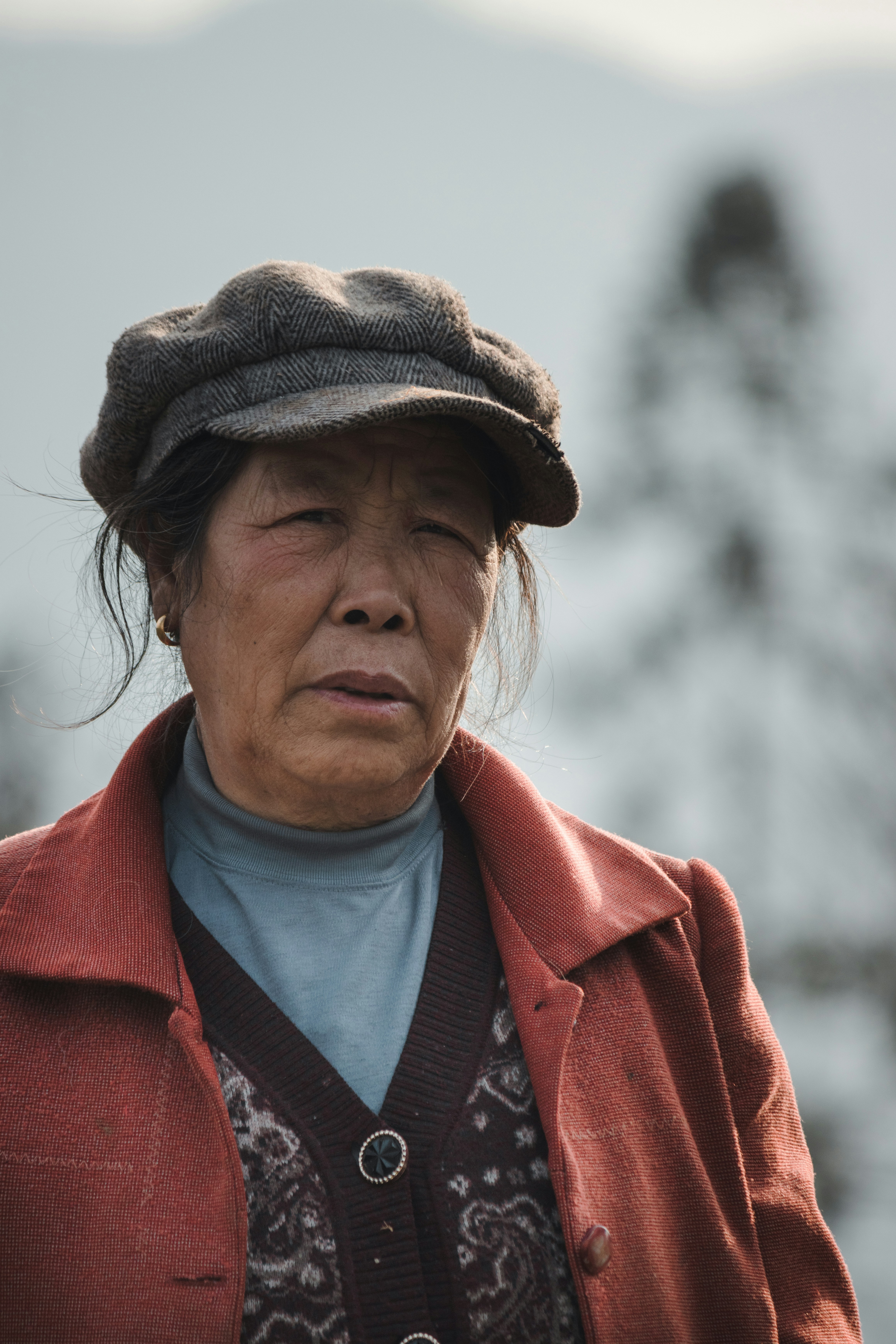 woman in red coat and brown hat