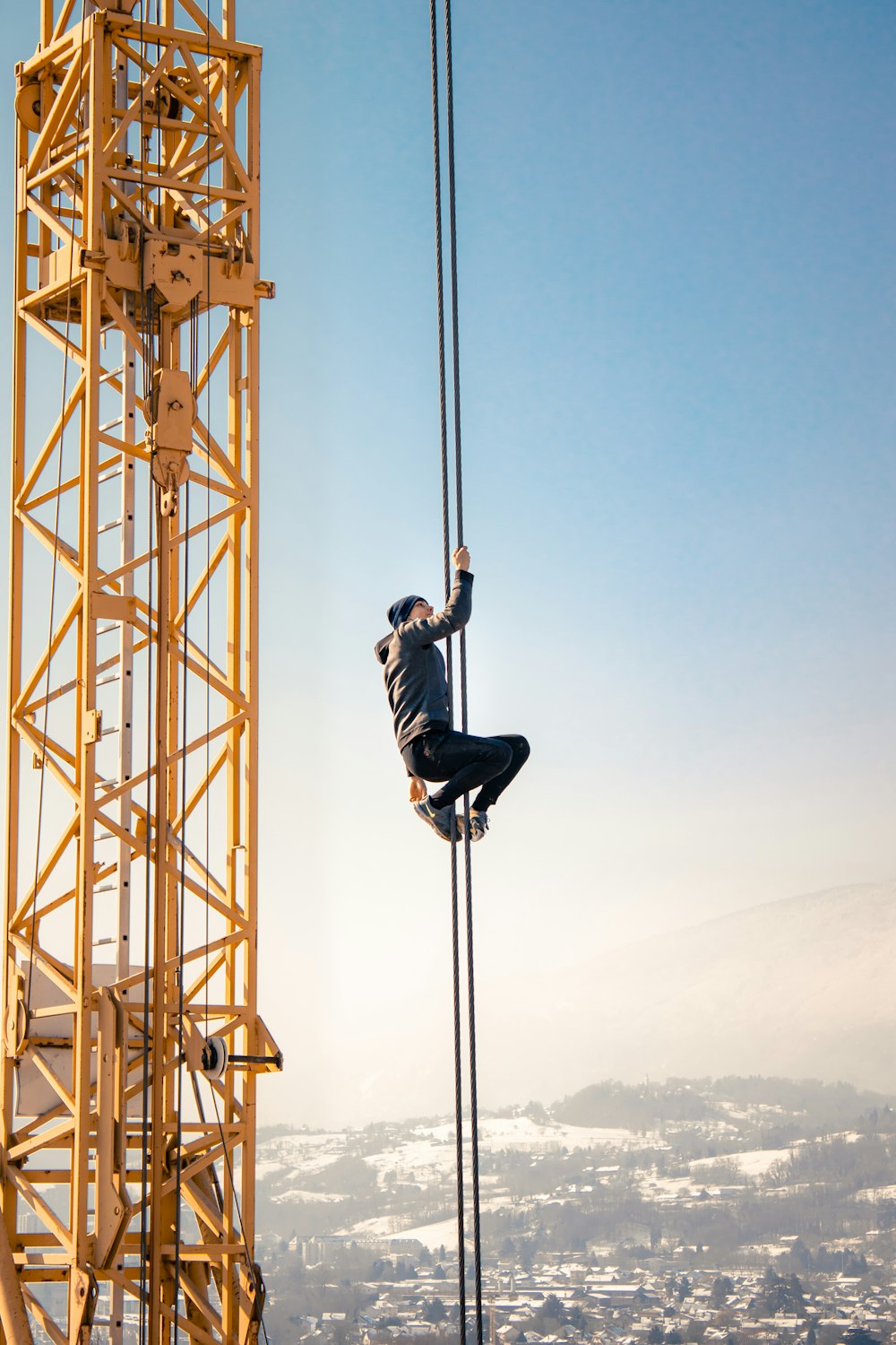 man in black jacket and pants standing on tower during daytime