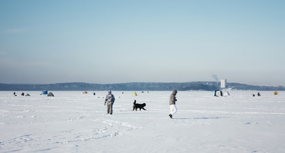 people walking on snow covered field during daytime