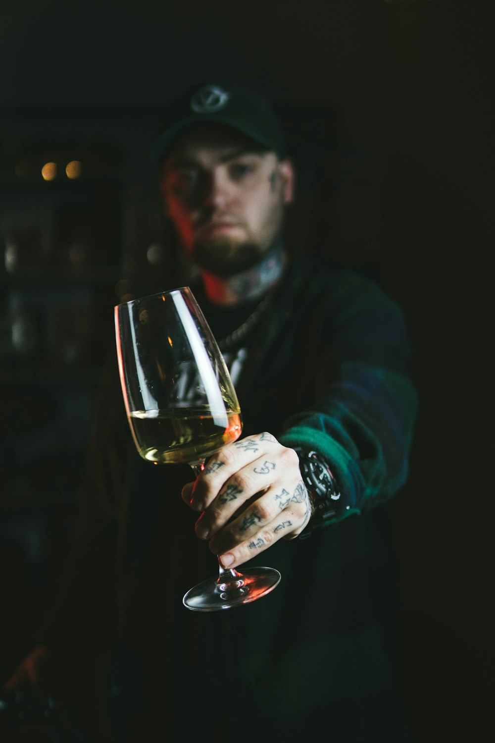man in blue long sleeve shirt holding clear wine glass