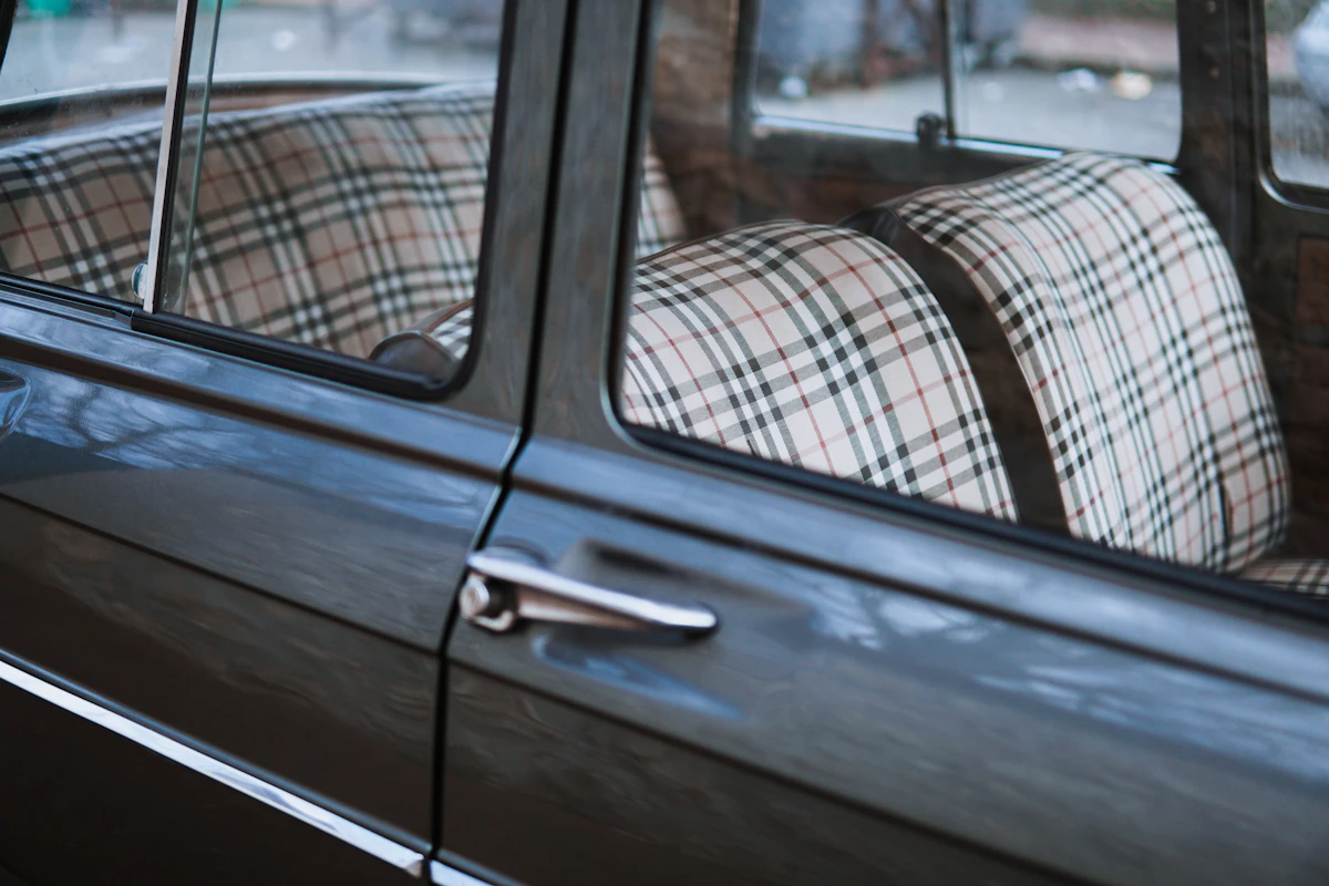Chauffeur opening the door of a luxury car