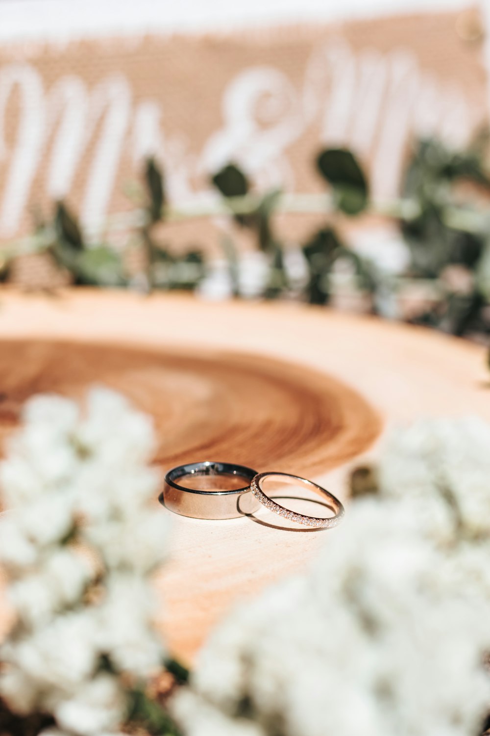 silver wedding band on brown wooden round table