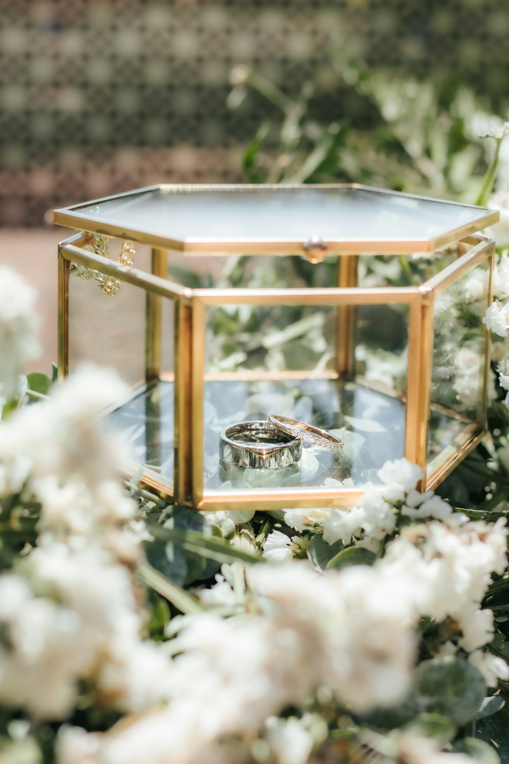 silver ring on clear glass container