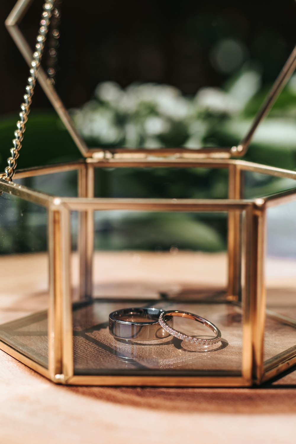 silver framed black lens sunglasses on brown wooden table