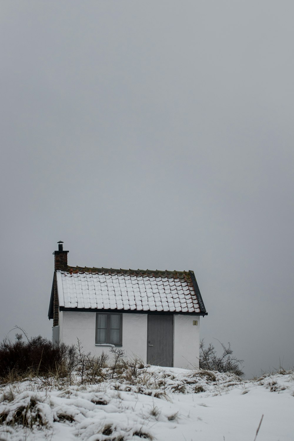 white and brown house under white sky