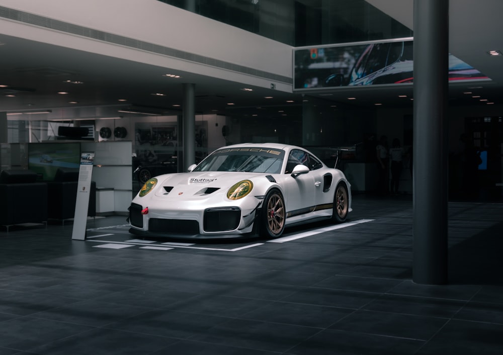 white bmw m 3 coupe parked in building