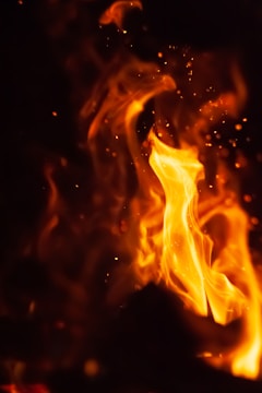 Close-up of a dragon’s breath with vibrant flames and sparks.