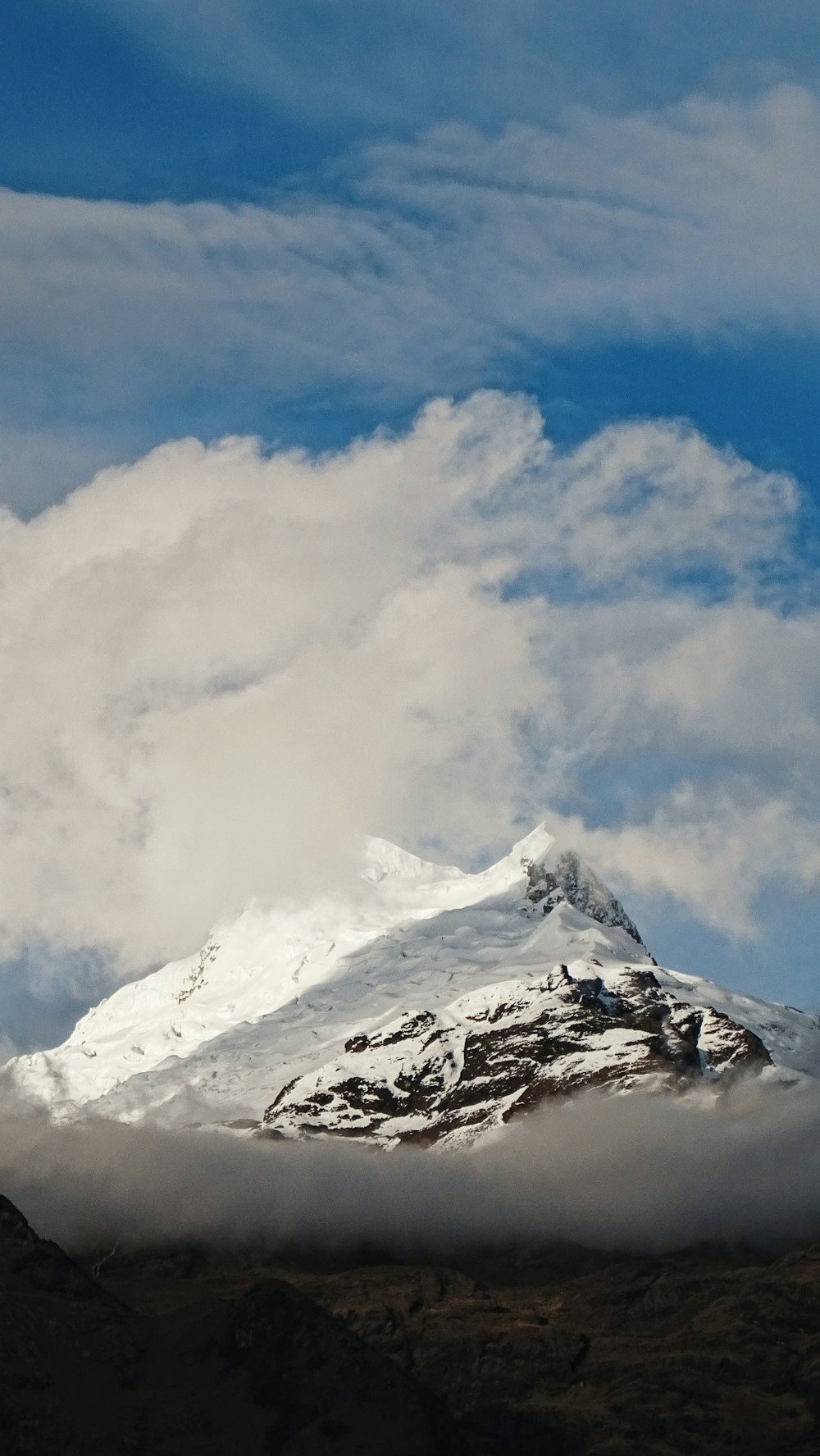 snow covered mountain under cloudy sky during daytime