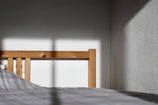 Modern bed with a wooden frame and colorful bedding in a bright room