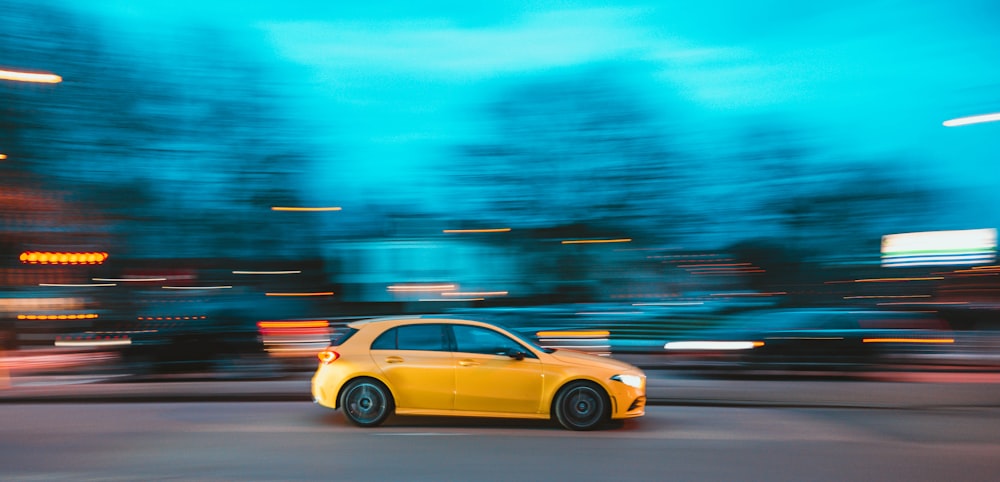 yellow sedan on road during daytime