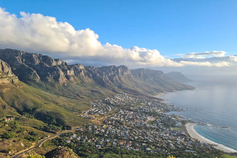 aerial view of green and brown mountains under blue sky during daytime