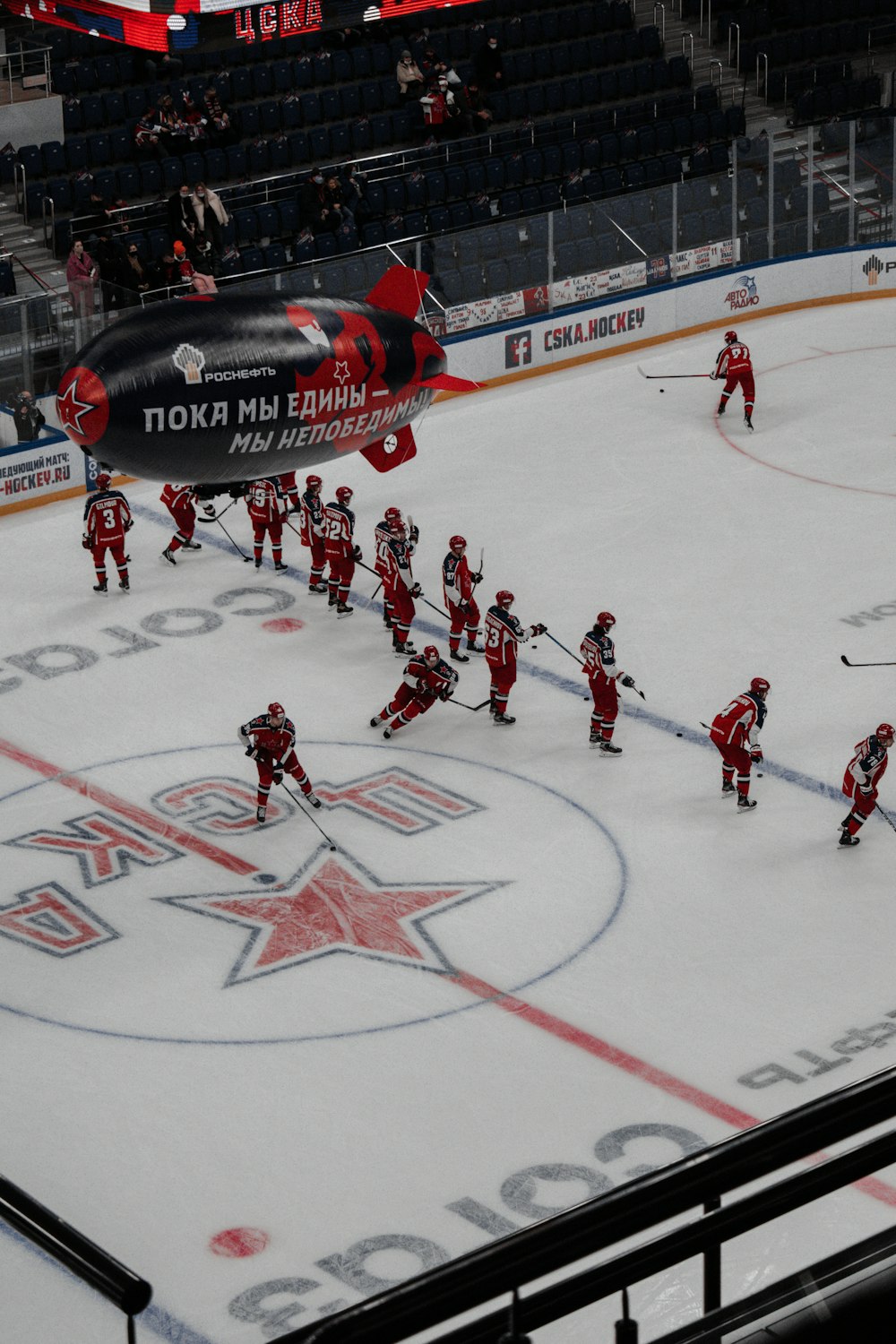 people playing ice hockey on ice field