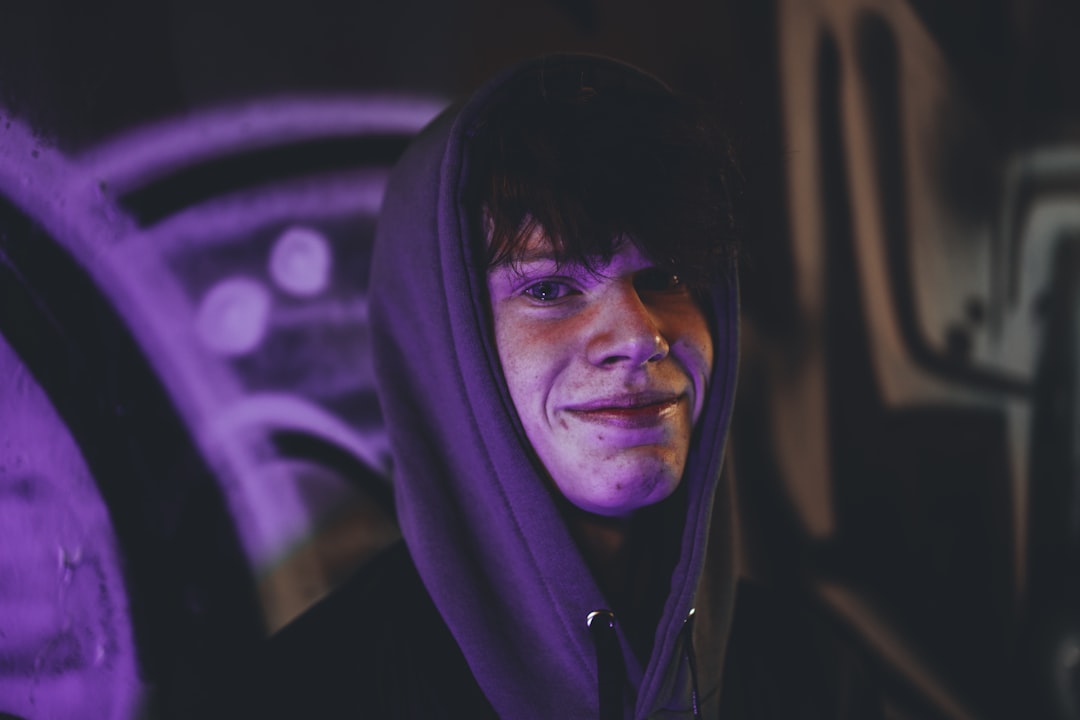 man in black hoodie with purple lights