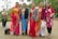 A diverse group of women wearing stylish outfits in a bright, outdoor setting.