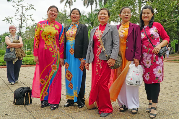 A warm group photo of diverse women from the association smiling together outdoors.
