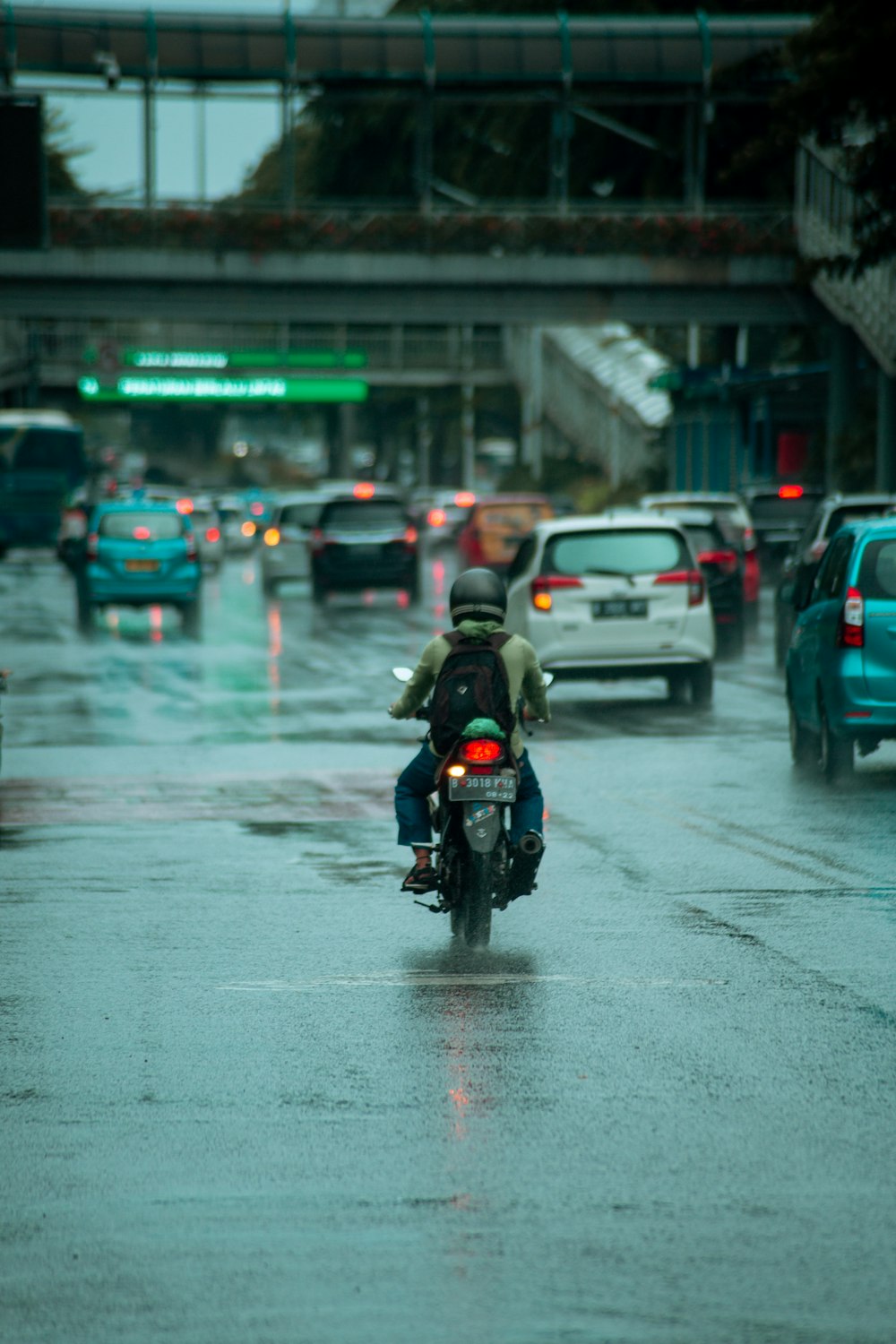 man in black jacket riding motorcycle on road during daytime