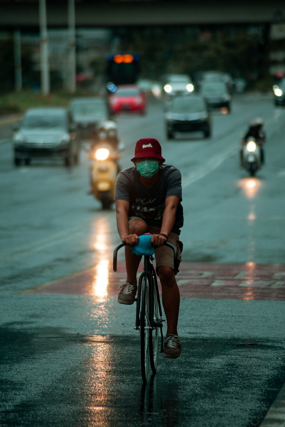 man in black t-shirt riding bicycle on road during daytime