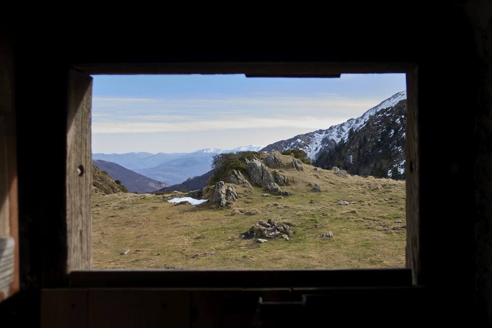 green grass field and mountains during daytime