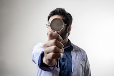 man in blue dress shirt wearing black framed eyeglasses