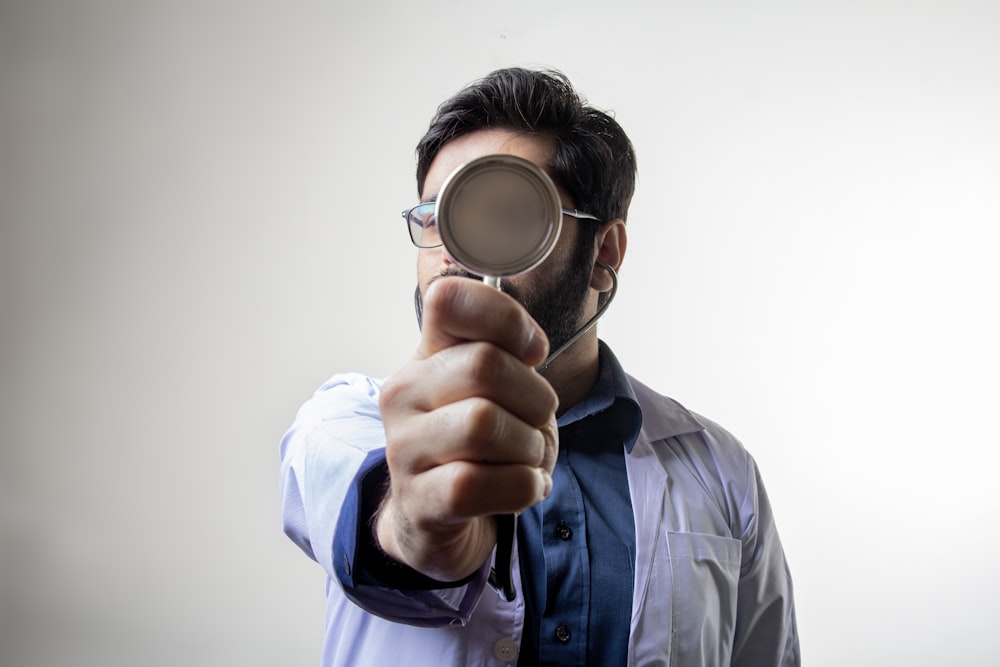 man in blue dress shirt wearing black framed eyeglasses