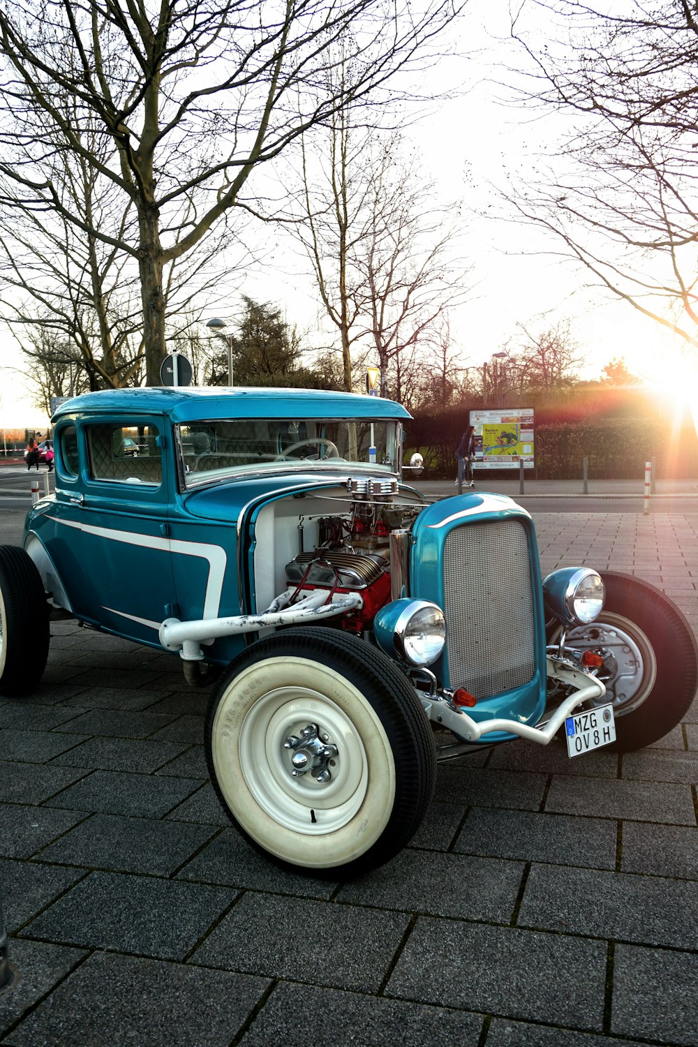 blue vintage car parked on sidewalk during daytime