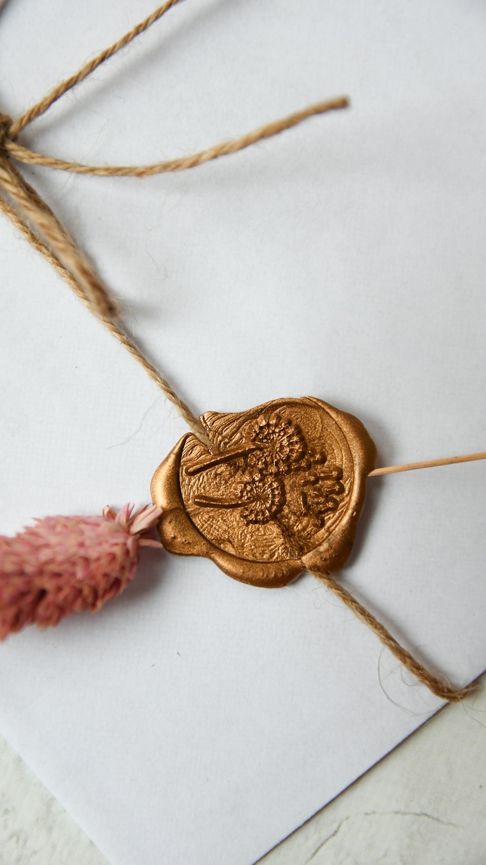 gold round coin on white textile