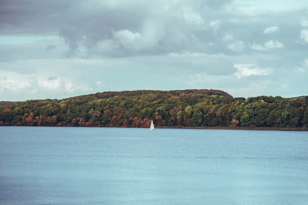 person in white shirt standing on white boat on sea during daytime