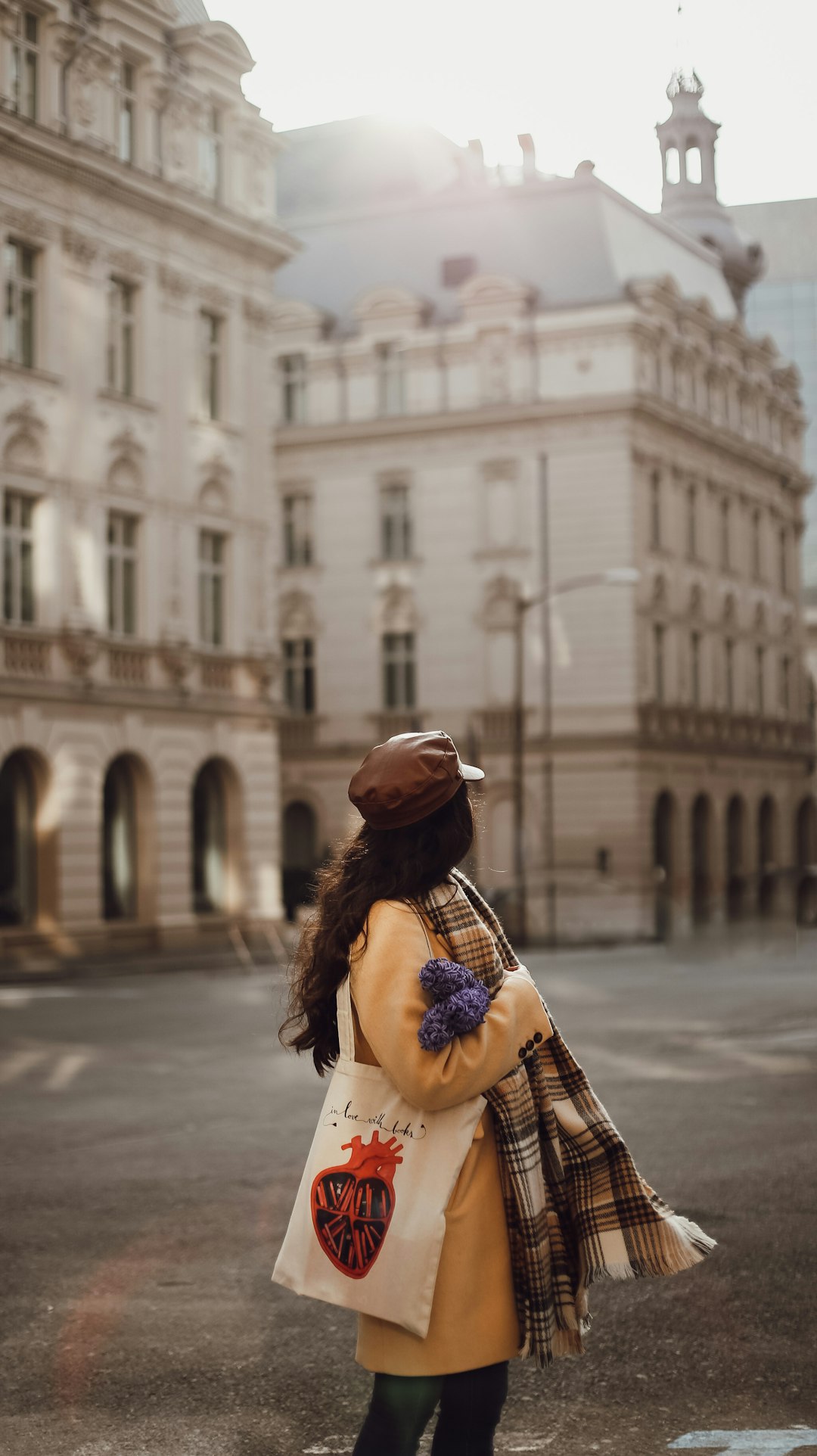 woman in brown and black hat and white dress standing on street during daytime