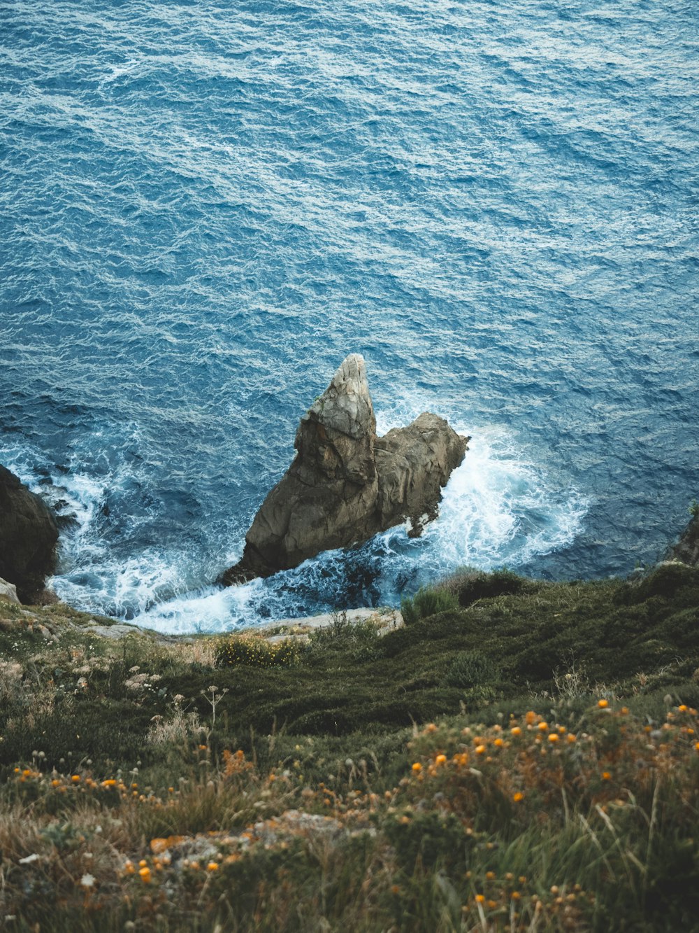 brown rock formation on sea during daytime