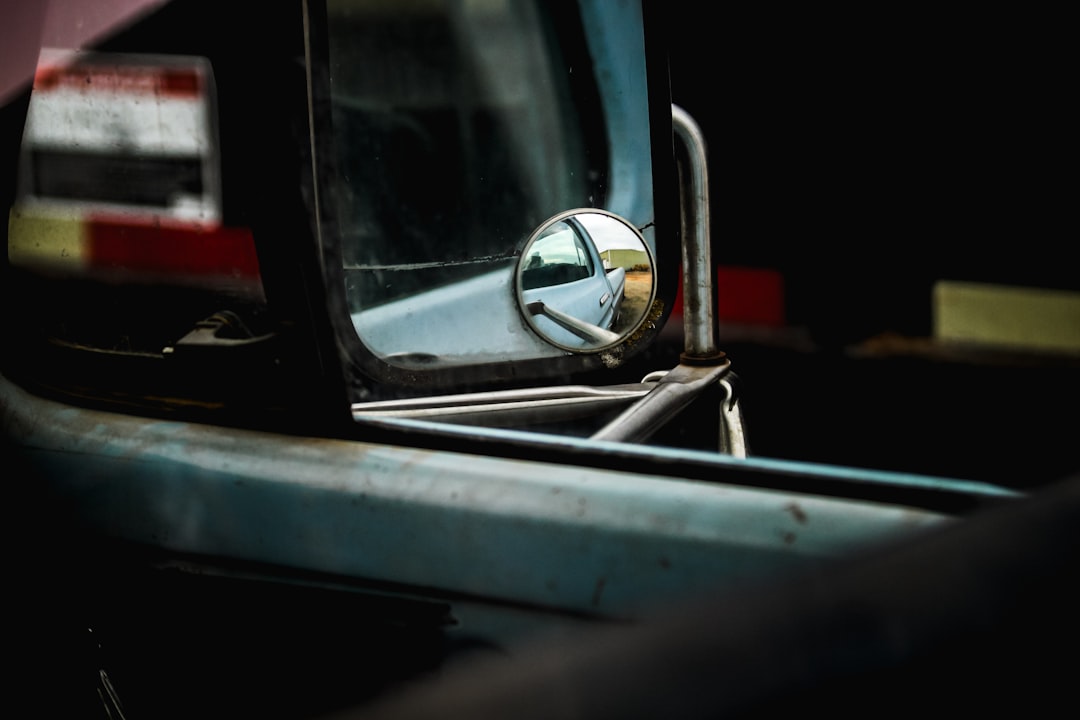 black car side mirror with red light