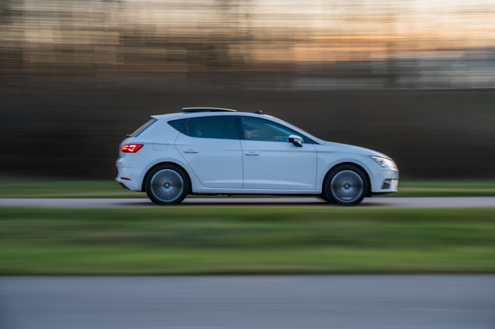 white 5 door hatchback on road during daytime