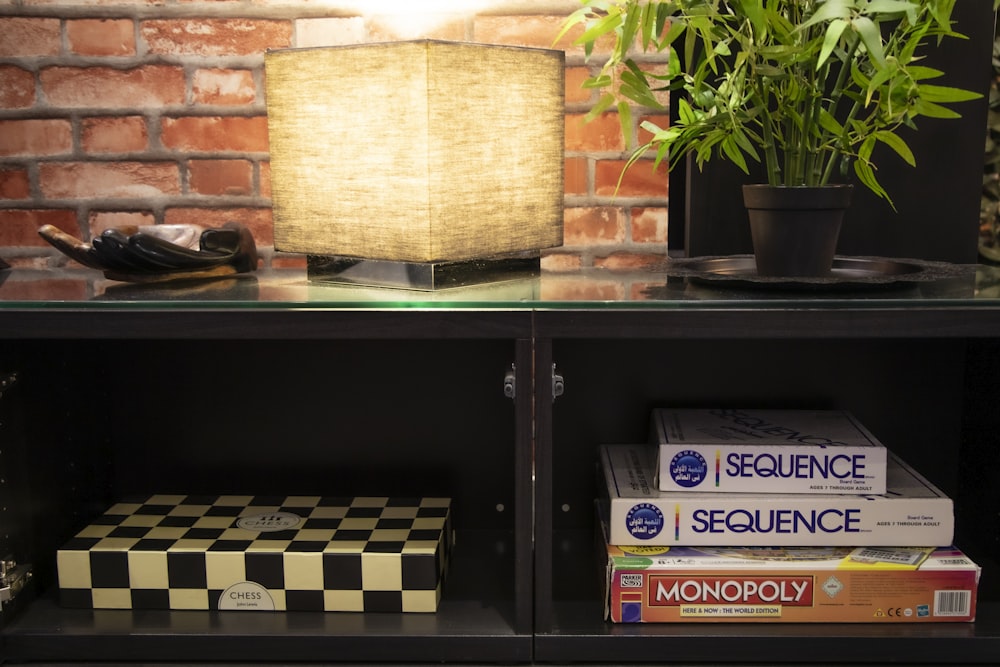 brown and black table lamp on black wooden shelf