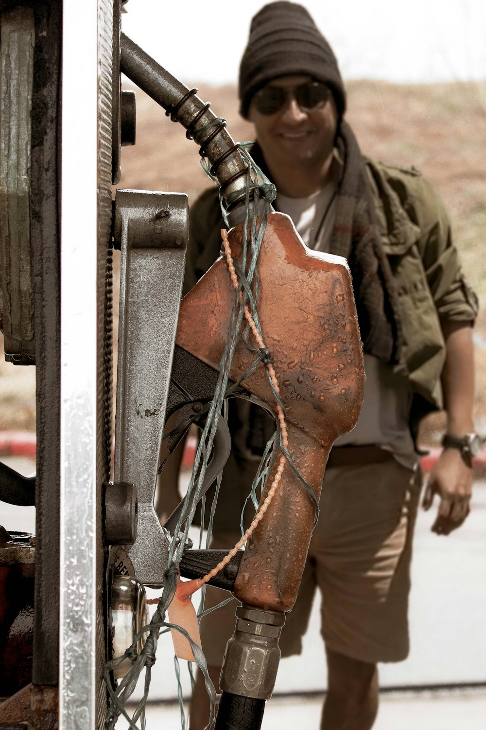 man in green and brown camouflage uniform holding orange metal tool