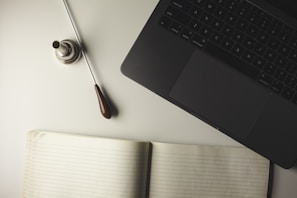 Artistic shot of sheet music and a conductor’s baton resting on a wooden table