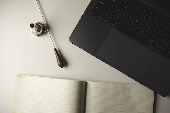 A warm, inviting workspace with a conductor's baton resting on sheet music.