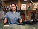 woman in blue button up shirt smiling