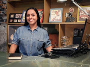 woman in blue button up shirt smiling