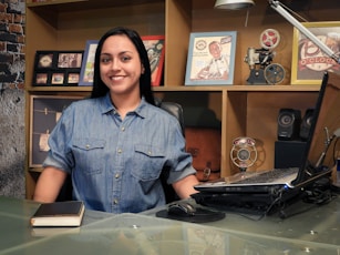 woman in blue button up shirt smiling