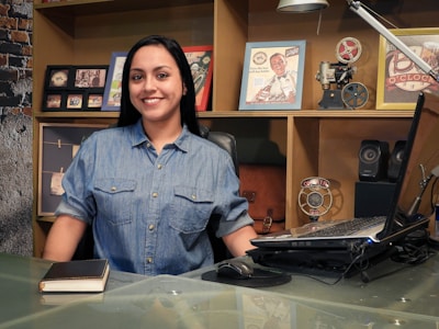 woman in blue button up shirt smiling
