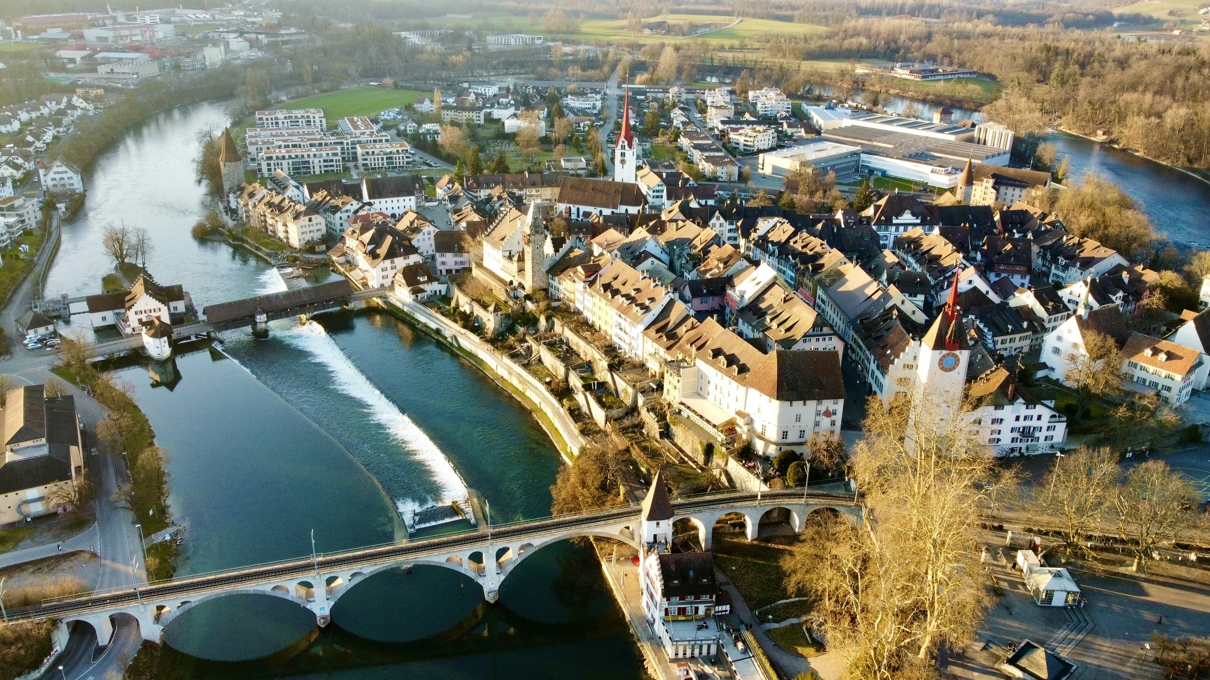 aerial view of city buildings near river during daytime