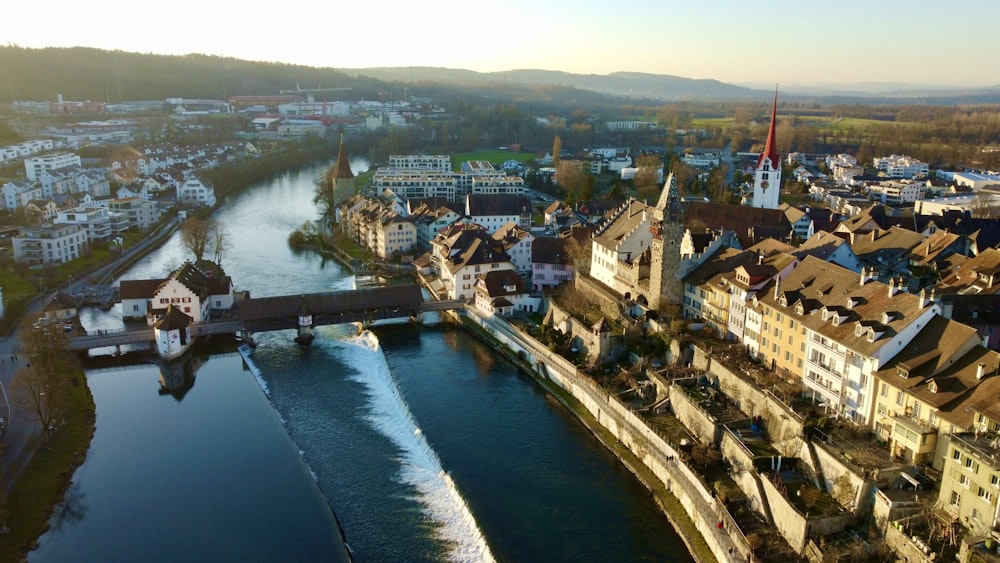 aerial view of city buildings near body of water during daytime