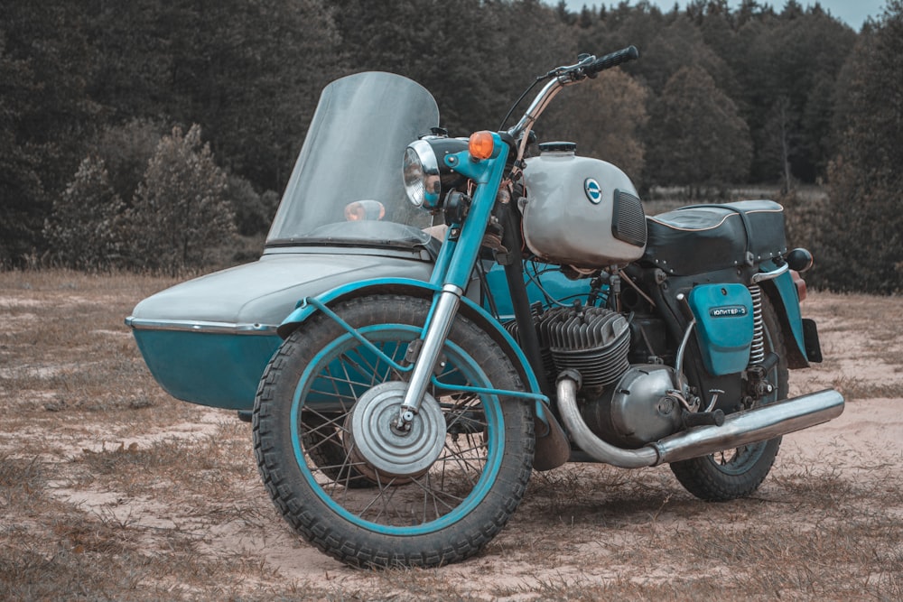 white and black motorcycle on brown dirt road during daytime