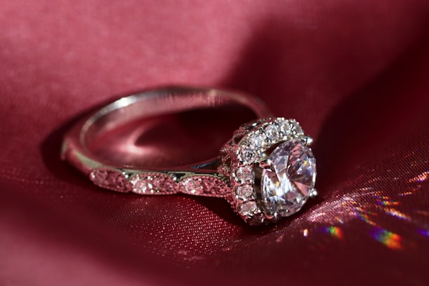 Happy customer wearing an elegant sapphire ring, smiling softly.