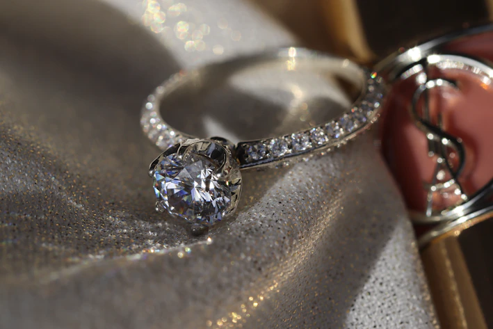 Close-up of a sparkling diamond ring on a velvet cushion