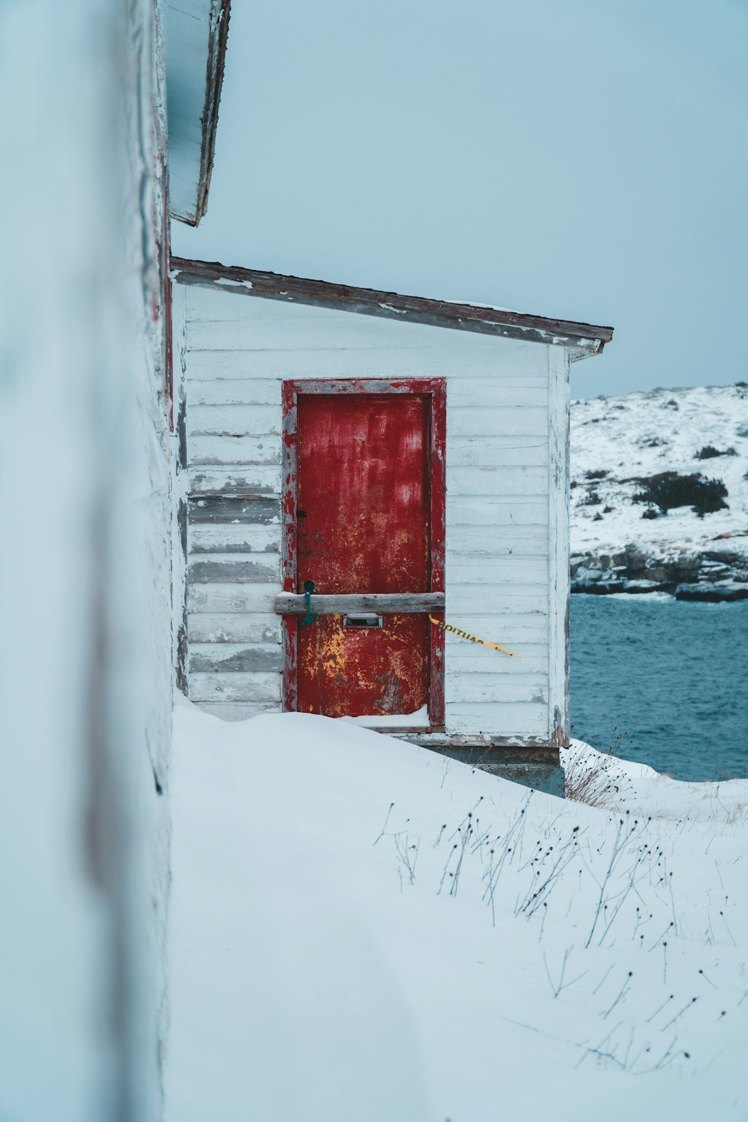 red and white wooden house on snow covered ground