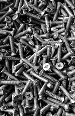 silver screw lot on brown wooden table