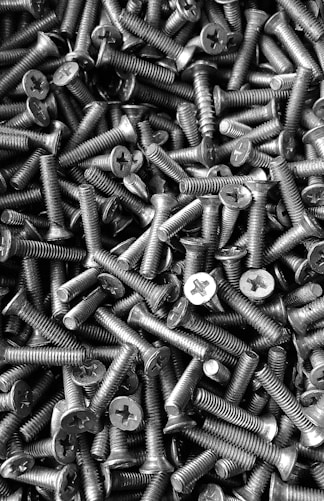 silver screw lot on brown wooden table