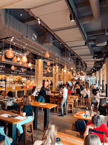 Happy diners enjoying their meals together in a welcoming, modern dining space.