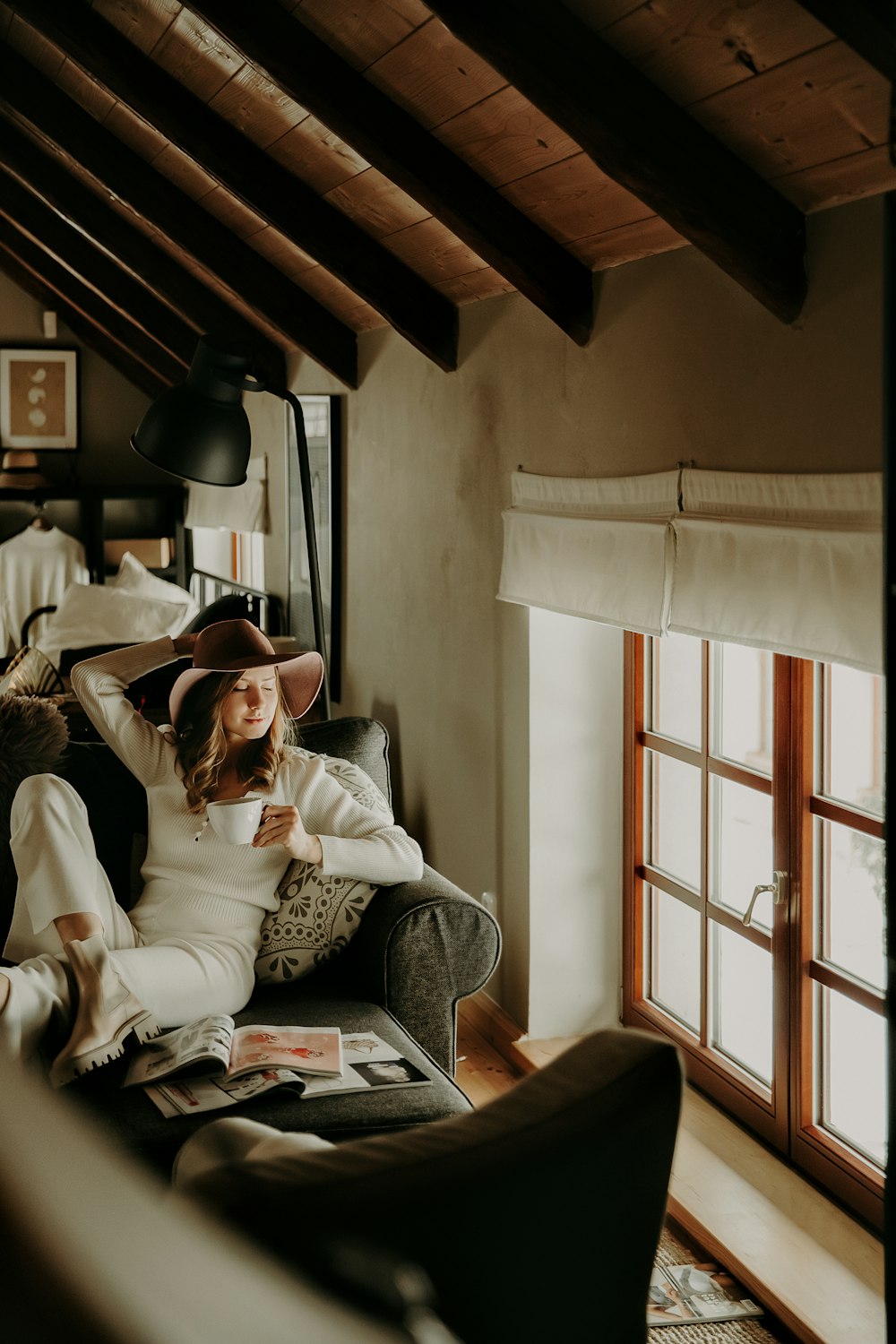 man in white dress shirt sitting on white couch